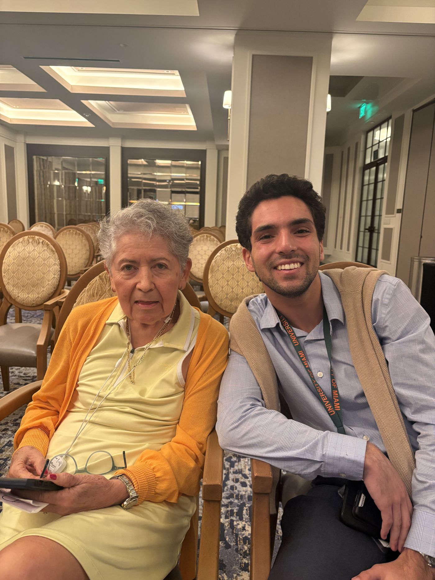 A Tech Connect member sitting beside an older woman who is taking notes during a one to one session.