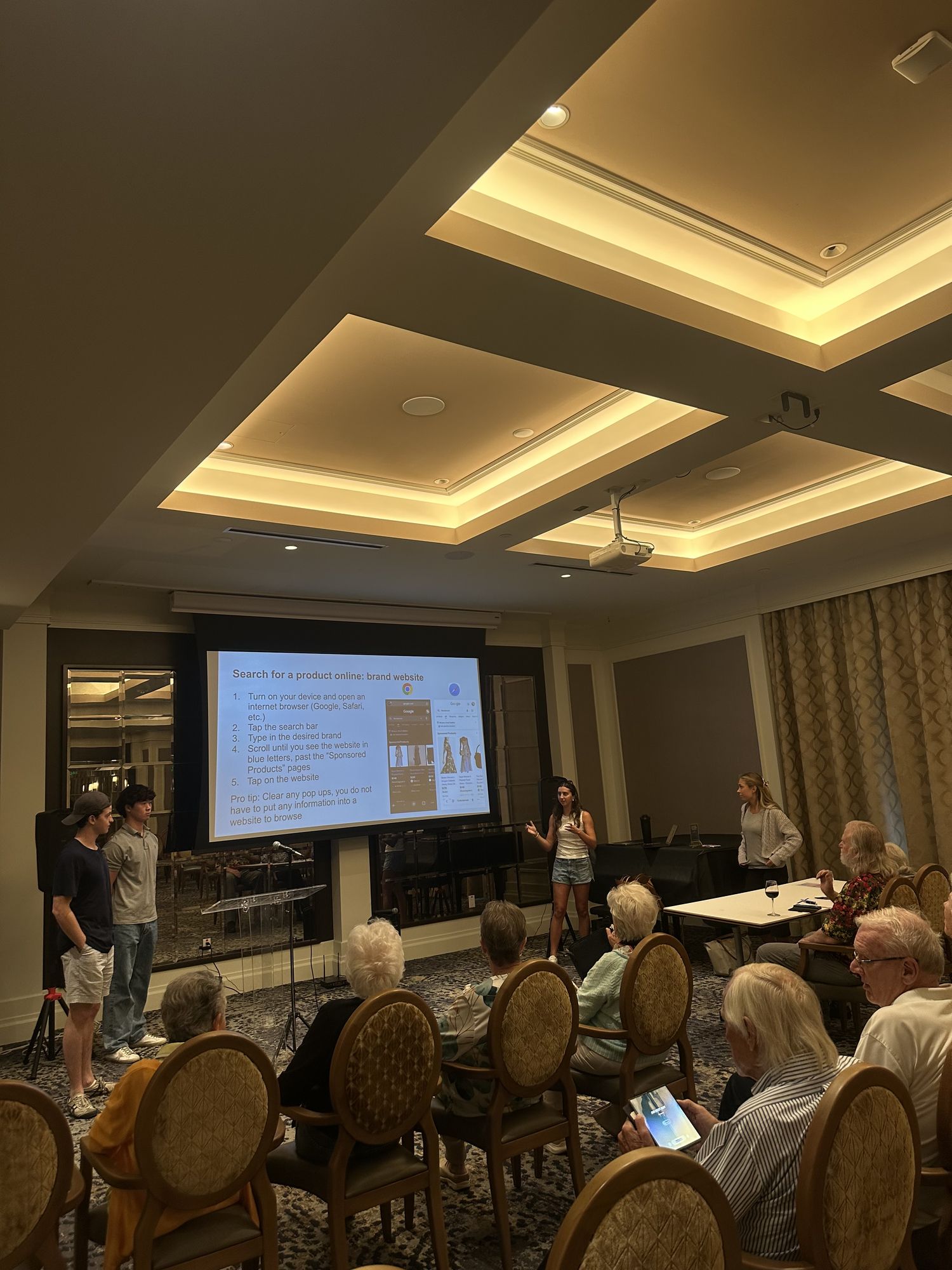 Tech Connect members presenting step by step browser instructions on a projector screen.